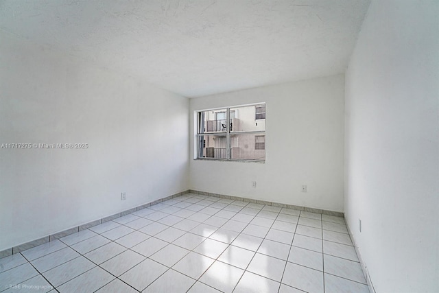 spare room featuring light tile patterned floors