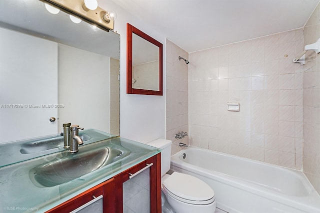 full bathroom with toilet, vanity, and tiled shower / bath