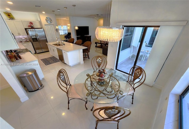 dining area with light tile patterned floors and sink