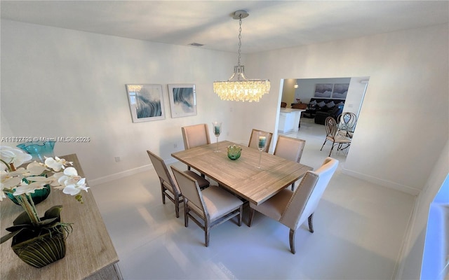 dining space with a chandelier