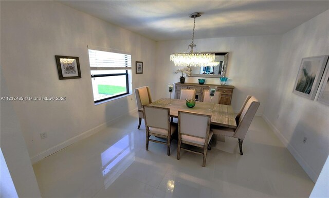 dining room with tile patterned flooring and an inviting chandelier