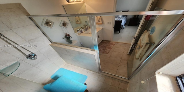 bathroom with tiled shower and vanity