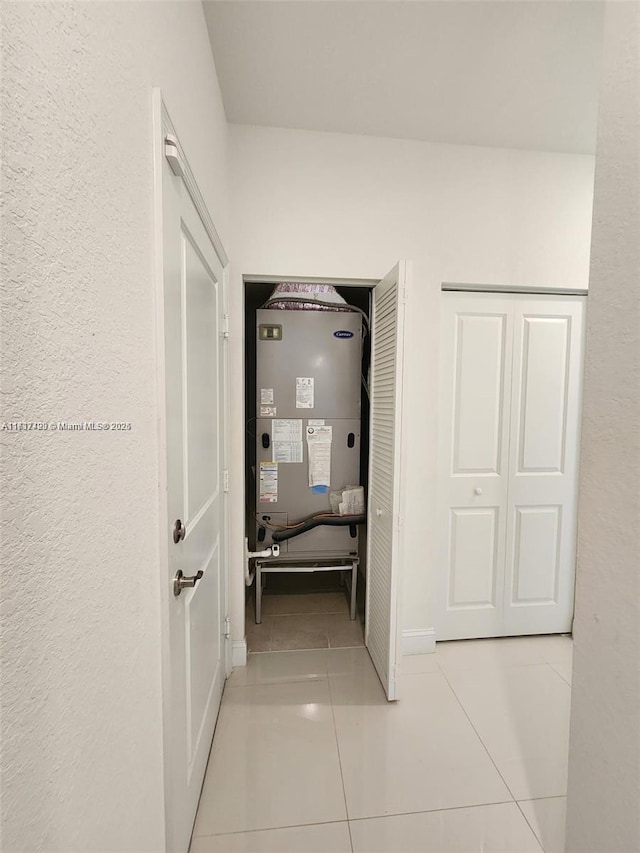 corridor with light tile patterned floors