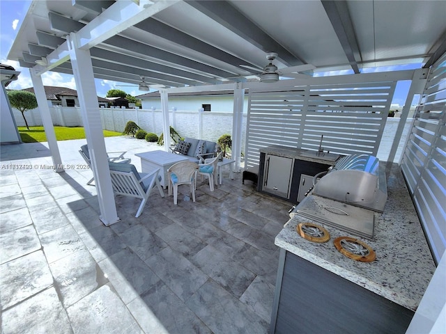 view of patio featuring an outdoor kitchen and ceiling fan