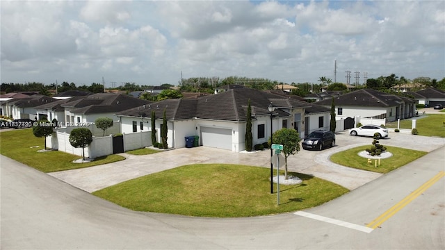 single story home featuring a front lawn and a garage