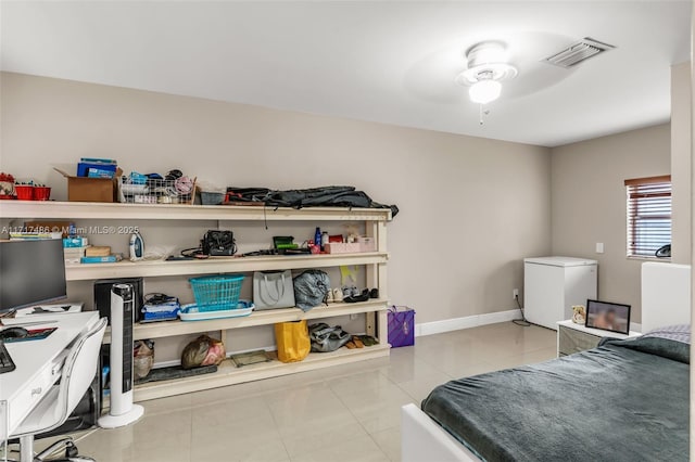 bedroom featuring ceiling fan, refrigerator, and light tile patterned floors