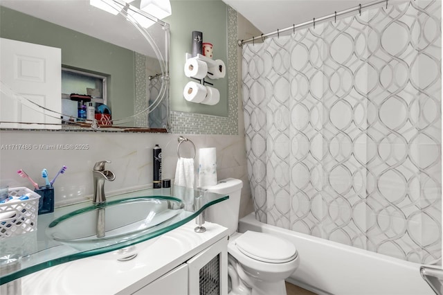 full bathroom with vanity, shower / bath combination with curtain, tile walls, and toilet