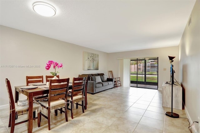 dining area with light tile patterned floors