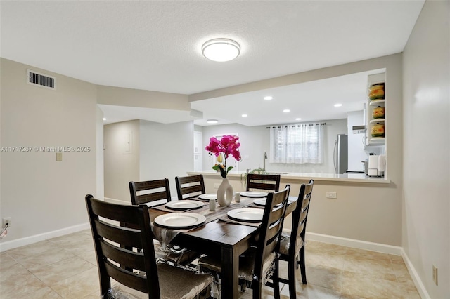 dining space featuring a textured ceiling