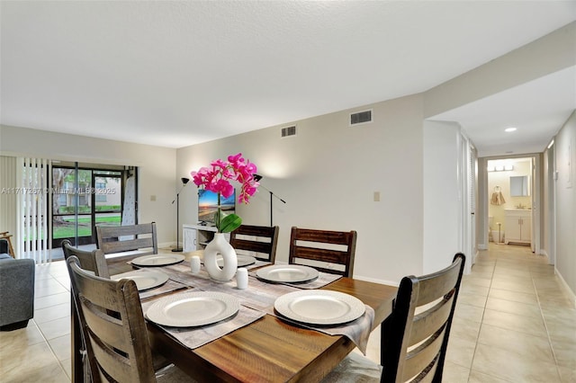 dining space with light tile patterned floors