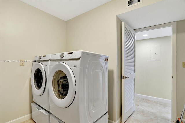 washroom with washing machine and clothes dryer