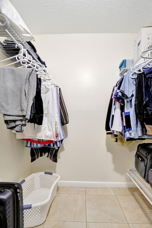 walk in closet featuring tile patterned flooring