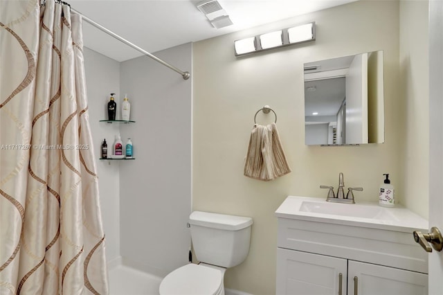 bathroom with vanity, curtained shower, and toilet