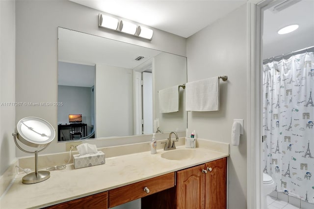 bathroom featuring walk in shower, tile patterned floors, vanity, and toilet