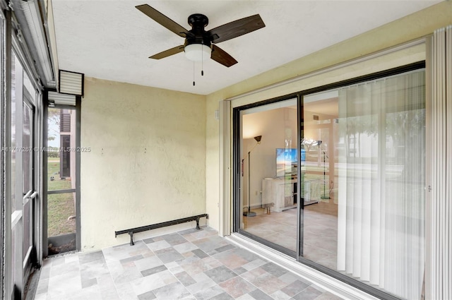 unfurnished sunroom featuring plenty of natural light and ceiling fan