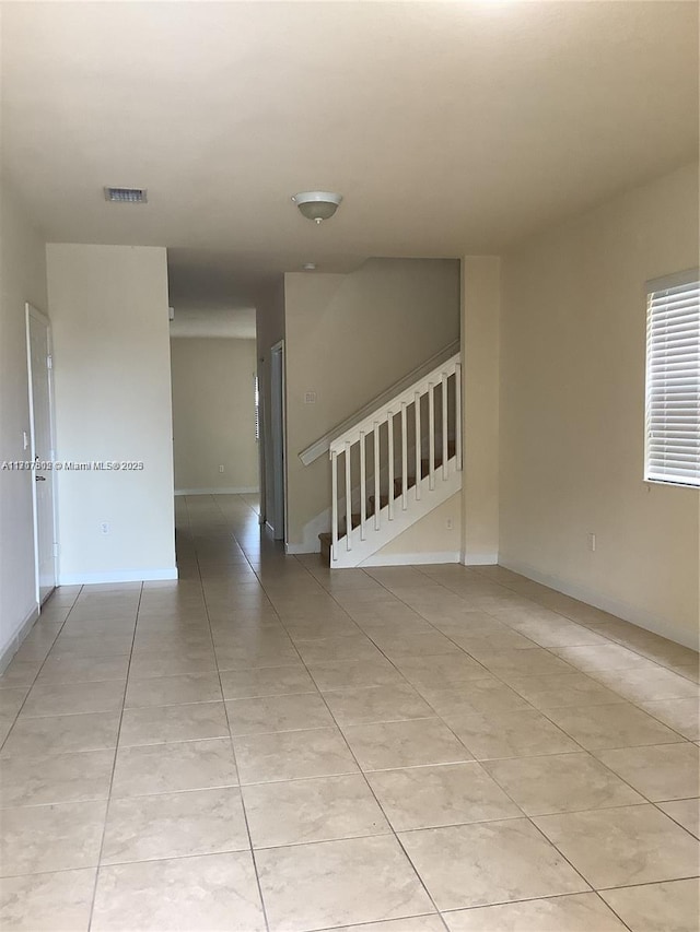 spare room with light tile patterned floors