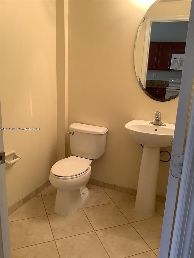 bathroom with tile patterned flooring and toilet