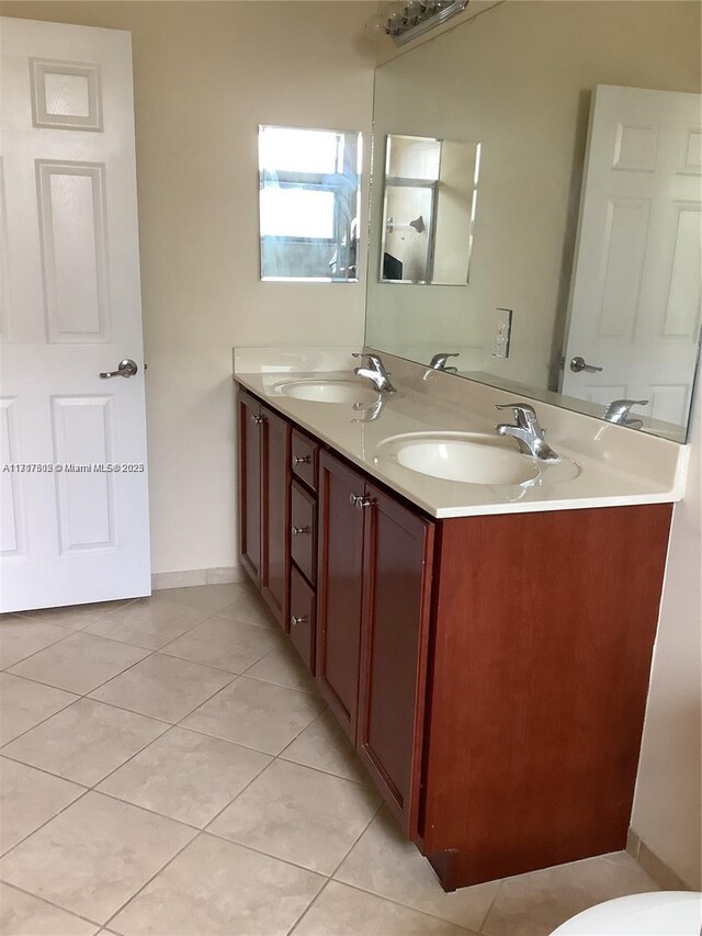 bathroom with tile patterned flooring and vanity