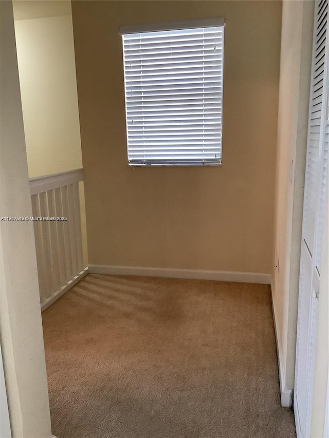 empty room featuring light colored carpet