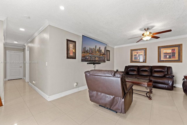 living room with light tile patterned floors, a textured ceiling, ceiling fan, and ornamental molding