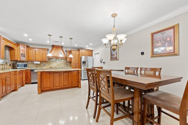 dining area featuring a chandelier, sink, crown molding, and light tile patterned flooring