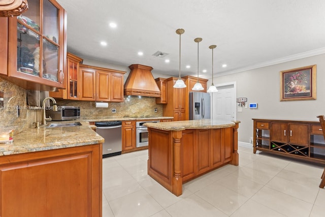 kitchen featuring custom range hood, stainless steel appliances, sink, a center island, and hanging light fixtures