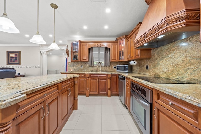 kitchen featuring sink, premium range hood, pendant lighting, appliances with stainless steel finishes, and ornamental molding