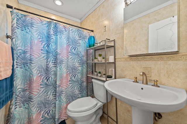 bathroom featuring crown molding, sink, tile walls, and toilet