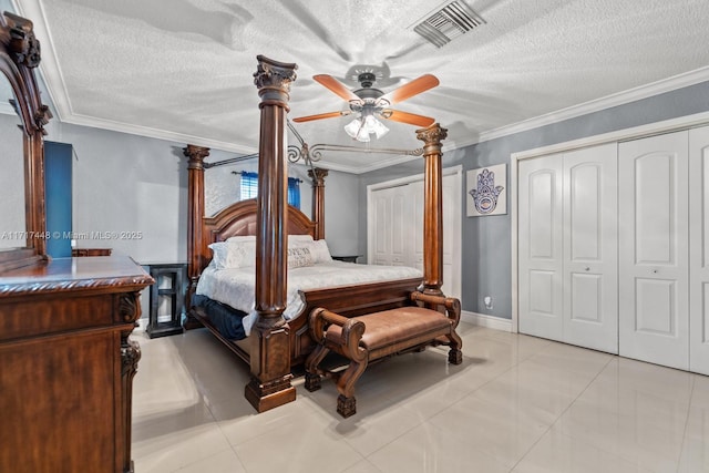 bedroom featuring ceiling fan, light tile patterned floors, a textured ceiling, and ornamental molding