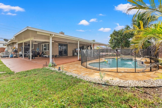 view of pool featuring a patio area and a yard