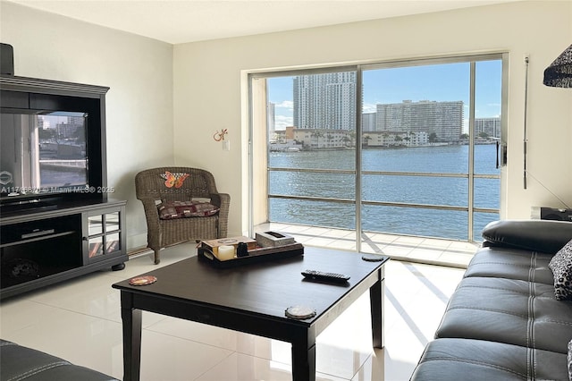 living room with a water view and tile patterned floors