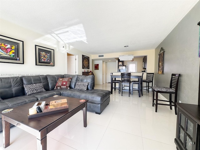 living room with light tile patterned floors and a textured ceiling