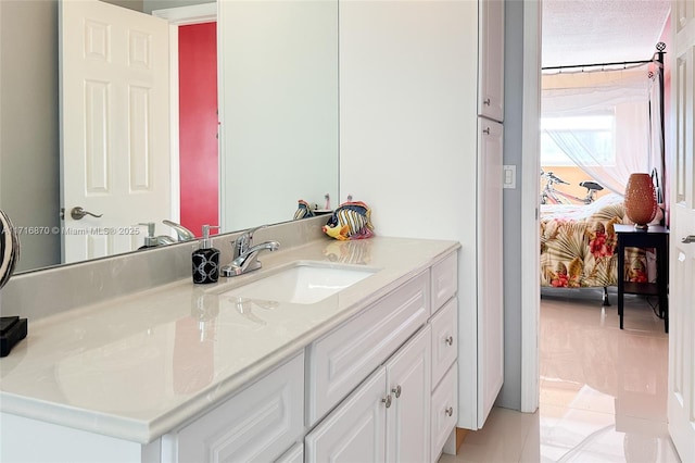 bathroom featuring tile patterned floors, vanity, and a textured ceiling