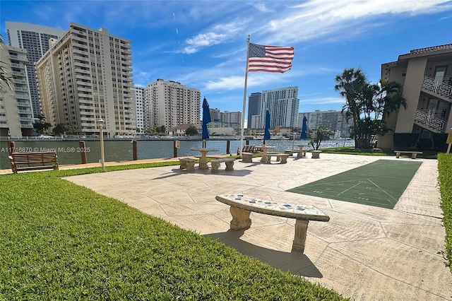 view of property's community with a yard and a water view