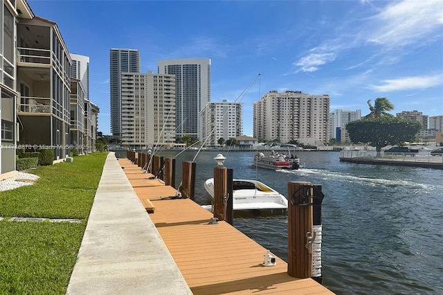 dock area with a lawn, a water view, and central air condition unit