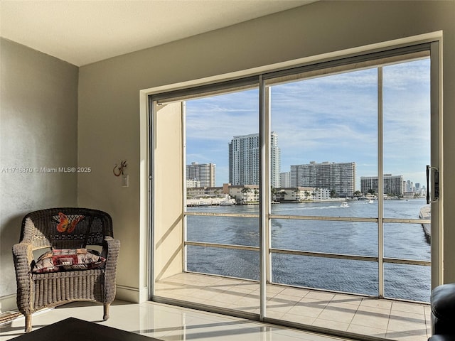 doorway to outside featuring tile patterned flooring and a water view