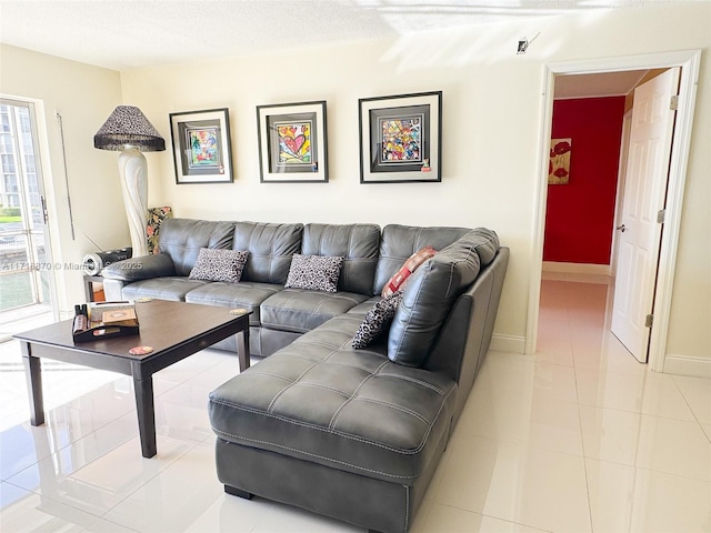 living room with light tile patterned floors and a textured ceiling