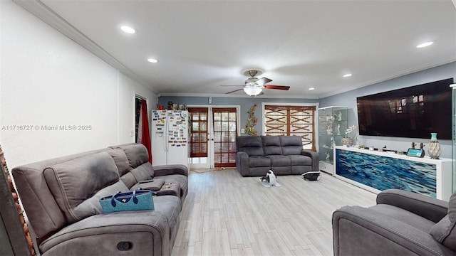 living room featuring french doors, light hardwood / wood-style floors, ceiling fan, and ornamental molding