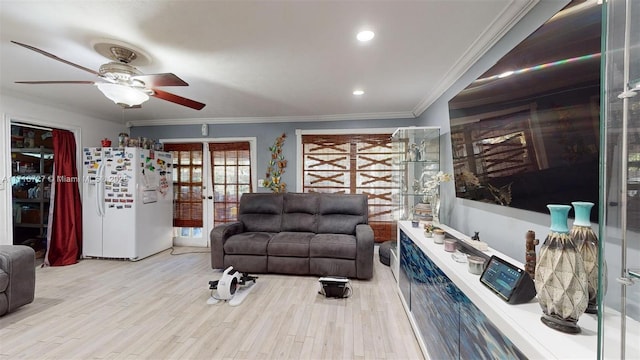 living room with ceiling fan, light hardwood / wood-style flooring, and ornamental molding