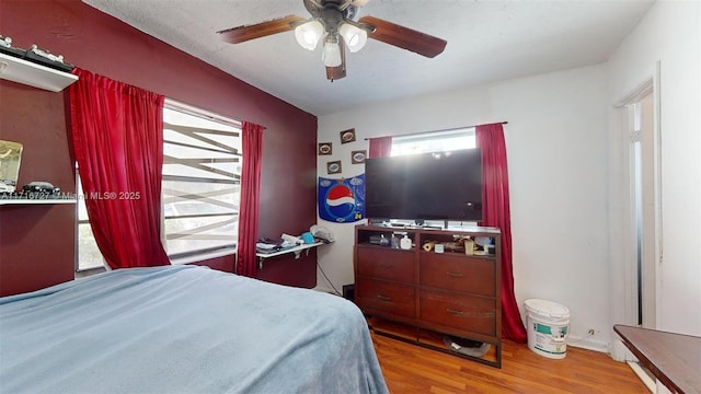 bedroom with wood-type flooring and ceiling fan