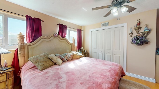 bedroom with ceiling fan, a closet, and light wood-type flooring