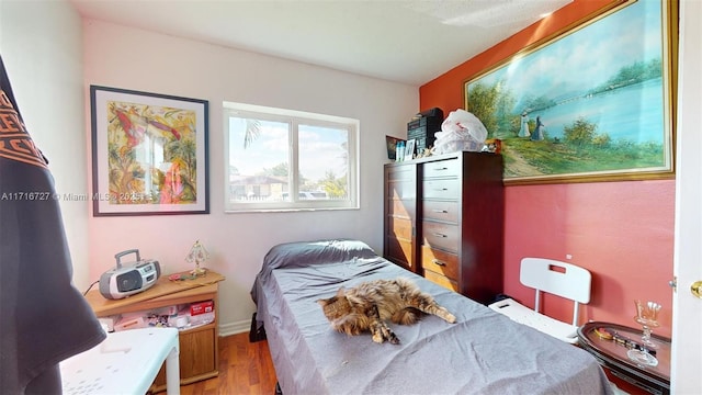 bedroom with hardwood / wood-style flooring