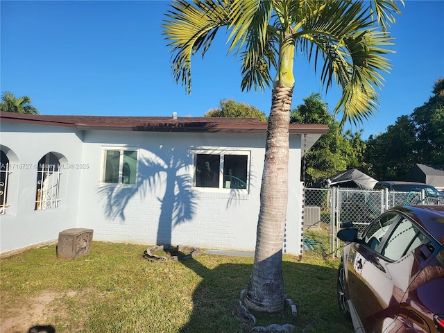 view of side of home featuring a yard