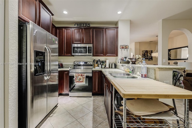 kitchen with light tile patterned floors, sink, and appliances with stainless steel finishes