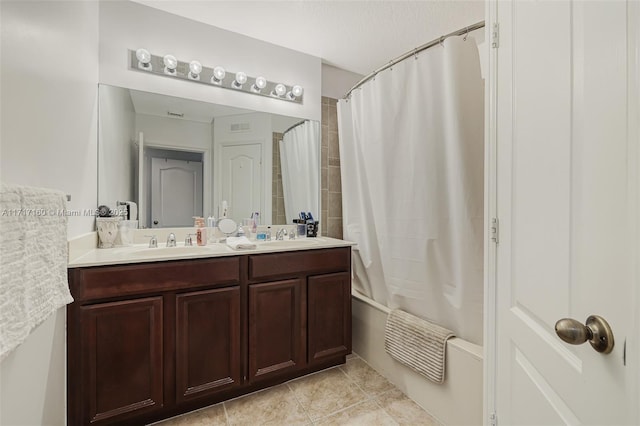 bathroom featuring tile patterned floors, vanity, and shower / bath combo with shower curtain