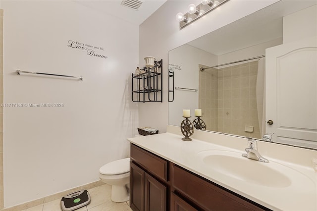 bathroom featuring tile patterned floors, vanity, toilet, and walk in shower