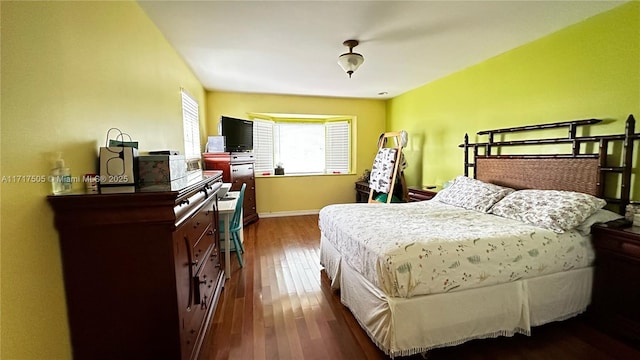 bedroom with dark hardwood / wood-style flooring