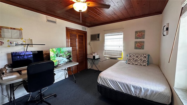 carpeted bedroom with ceiling fan, crown molding, wooden ceiling, and a wall mounted air conditioner