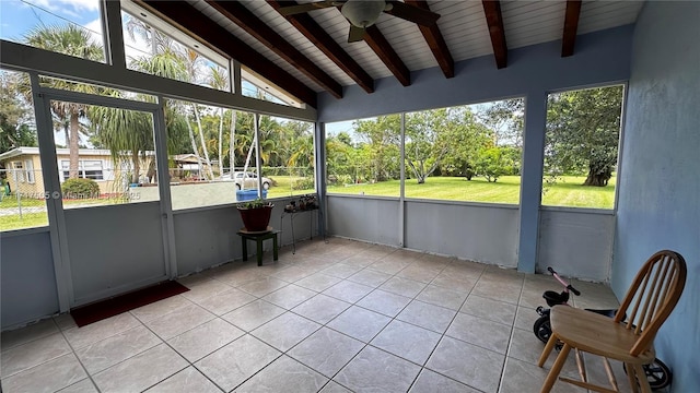 unfurnished sunroom featuring vaulted ceiling with beams, ceiling fan, and wooden ceiling