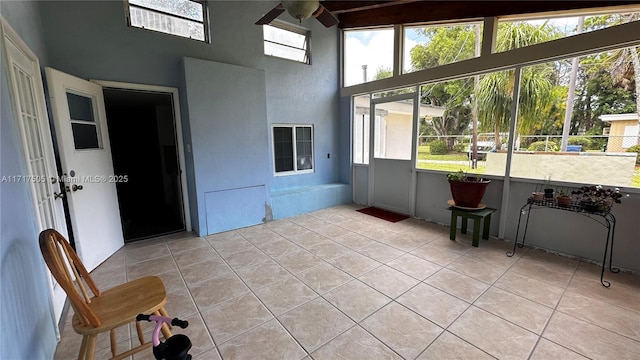 unfurnished sunroom featuring ceiling fan